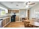 Well-lit kitchen featuring wood cabinetry, modern appliances, and dining area with wood table at 205 S Higley Rd # 293, Mesa, AZ 85206