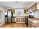 Bright kitchen featuring stainless steel appliances, wood cabinetry, and ample counter space at 205 S Higley Rd # 293, Mesa, AZ 85206