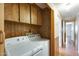 This functional laundry room features a side-by-side washer and dryer and ample cabinet space at 205 S Higley Rd # 293, Mesa, AZ 85206