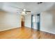 Bright living room with light wood floors, ceiling fan, and large window with curtains at 205 S Higley Rd # 293, Mesa, AZ 85206