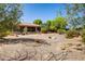 Expansive backyard featuring desert landscaping, patio seating, and a covered porch at 21384 E Excelsior Ave, Queen Creek, AZ 85142