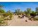 View of the backyard featuring a patio and lush landscaping at 21384 E Excelsior Ave, Queen Creek, AZ 85142