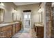 Dual vanities with custom wood cabinets and granite countertops in the spacious bathroom at 21384 E Excelsior Ave, Queen Creek, AZ 85142