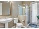 Bright bathroom with pedestal sink and glass-enclosed shower at 21384 E Excelsior Ave, Queen Creek, AZ 85142