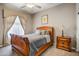 Bedroom with bed, window, night stand and carpet at 21384 E Excelsior Ave, Queen Creek, AZ 85142