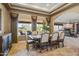 Elegant dining room with large windows, tray ceiling, and comfortable seating for Gathering gatherings or formal entertaining at 21384 E Excelsior Ave, Queen Creek, AZ 85142