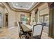 Dining room with large windows, custom window treatments, and a decorative mirror adding style and elegance to the space at 21384 E Excelsior Ave, Queen Creek, AZ 85142