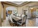 Sophisticated dining room showcasing a large table, beautiful chairs, and a view into multiple rooms, creating an open feel at 21384 E Excelsior Ave, Queen Creek, AZ 85142
