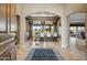 Spacious foyer featuring tile flooring, an elegant arched doorway, and a view into the bright dining room at 21384 E Excelsior Ave, Queen Creek, AZ 85142