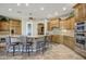 Gourmet kitchen with custom wood cabinets, granite countertops, stainless steel appliances, and a breakfast bar at 21384 E Excelsior Ave, Queen Creek, AZ 85142