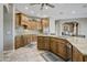 Well-appointed kitchen featuring custom cabinetry, granite countertops, and a center island with a sink at 21384 E Excelsior Ave, Queen Creek, AZ 85142