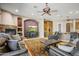 Open-concept living room featuring a stone fireplace, media center, and bar area, making it ideal for entertaining guests at 21384 E Excelsior Ave, Queen Creek, AZ 85142