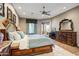 Well appointed main bedroom with a large bed, a ceiling fan, and access to the backyard at 21384 E Excelsior Ave, Queen Creek, AZ 85142