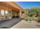 Covered patio with seating and view of the backyard and landscaping at 21384 E Excelsior Ave, Queen Creek, AZ 85142