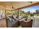Covered outdoor patio with cushioned seating around a gas fire pit at 21384 E Excelsior Ave, Queen Creek, AZ 85142