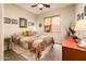 Comfortable bedroom featuring a ceiling fan, stylish decor, and natural light from the window at 2171 E Iris Dr, Chandler, AZ 85286