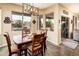 Inviting dining area features wood table, stylish light fixture, and views of the sparkling pool at 2171 E Iris Dr, Chandler, AZ 85286