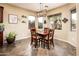 Charming dining area featuring a wooden table, natural lighting, and views of the backyard at 2171 E Iris Dr, Chandler, AZ 85286