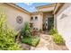 Welcoming front courtyard features a charming fountain, stone pathway, and lush landscaping for an inviting ambiance at 2171 E Iris Dr, Chandler, AZ 85286