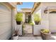 Inviting front entryway with potted plants and a decorative gate, adding charm and privacy at 2171 E Iris Dr, Chandler, AZ 85286