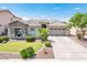 Charming home featuring a well-manicured front yard, stone accents, and a spacious driveway leading to a two-car garage at 2171 E Iris Dr, Chandler, AZ 85286