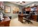Inviting home office with wood floors, built-in shelving, and a large desk for productivity at 2171 E Iris Dr, Chandler, AZ 85286
