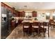 Gourmet kitchen with stainless steel appliances, dark wood cabinets, and a spacious island at 2171 E Iris Dr, Chandler, AZ 85286