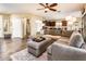 Comfortable living room with an oversized sectional sofa, neutral colors, and tile flooring at 2171 E Iris Dr, Chandler, AZ 85286