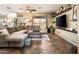 Inviting living room with a large sectional, mounted TV, and stylish decor at 2171 E Iris Dr, Chandler, AZ 85286