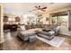 Spacious living room featuring a plush sectional sofa, ceiling fan, and views of the backyard oasis at 2171 E Iris Dr, Chandler, AZ 85286