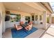 View of the covered patio with furniture and backyard pool from inside at 2171 E Iris Dr, Chandler, AZ 85286