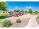 Community playground with slides and play structures in a landscaped area at 2171 E Iris Dr, Chandler, AZ 85286