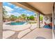 View of the backyard pool with waterfall and patio from under the covered patio at 2171 E Iris Dr, Chandler, AZ 85286