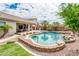 Aerial view of a backyard pool with rock waterfall feature and palm trees at 2171 E Iris Dr, Chandler, AZ 85286