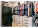 Walk-in closet is well organized and features ample shelving and drawers for clothing and accessories at 2171 E Iris Dr, Chandler, AZ 85286