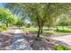 Paved walking path alongside a beautifully landscaped community park with trees and well-maintained grounds at 2171 E Iris Dr, Chandler, AZ 85286