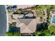 Striking aerial view of a luxury home showcasing a meticulously landscaped backyard, patio, and mature trees at 2383 E Zion Way, Chandler, AZ 85249