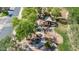 Community playground featuring mature trees, a covered play structure, swings, and nearby sidewalks at 2383 E Zion Way, Chandler, AZ 85249