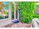 Charming back entrance with double doors, lush green foliage, and custom stone patio at 2383 E Zion Way, Chandler, AZ 85249