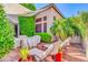 Spacious outdoor living area with shaded seating, lush greenery, and covered dining space at 2383 E Zion Way, Chandler, AZ 85249