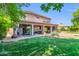 Expansive backyard features a well-manicured lawn, covered patio, and lush greenery at 2383 E Zion Way, Chandler, AZ 85249
