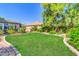 Green lawn and landscaping create a serene backyard oasis at 2383 E Zion Way, Chandler, AZ 85249