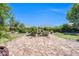 Landscaped backyard offers a calming water feature and a lush green space for outdoor enjoyment at 2383 E Zion Way, Chandler, AZ 85249