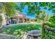 Expansive backyard features a covered patio, manicured lawn, mature landscaping, and a serene outdoor space at 2383 E Zion Way, Chandler, AZ 85249