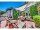 Beautiful backyard featuring a covered patio with a firepit, lounge chairs, and lush landscaping at 2383 E Zion Way, Chandler, AZ 85249