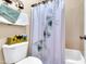 This bathroom features a toilet, a shower/tub combo, and storage shelves at 2383 E Zion Way, Chandler, AZ 85249