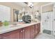 This bathroom features double sinks, a large mirror, and custom wood cabinets at 2383 E Zion Way, Chandler, AZ 85249