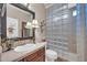 Well-lit bathroom featuring a glass block shower, vanity with a sink, and neutral decor at 2383 E Zion Way, Chandler, AZ 85249