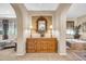 Elegant dressing table and mirror between bathroom and bedroom under arched room entrances at 2383 E Zion Way, Chandler, AZ 85249
