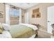 Comfortable bedroom with carpeted floors, and large window with white curtains, providing natural light at 2383 E Zion Way, Chandler, AZ 85249
